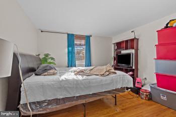 bedroom with hardwood / wood-style flooring