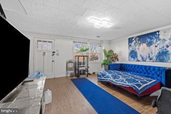 bedroom with wood-type flooring