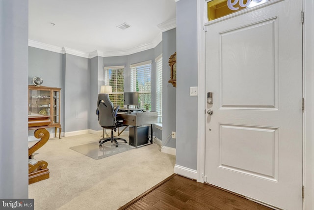 carpeted home office featuring crown molding