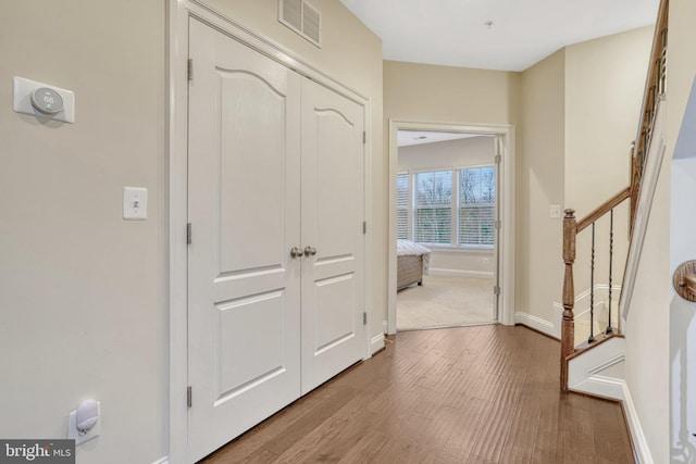 hall with hardwood / wood-style floors