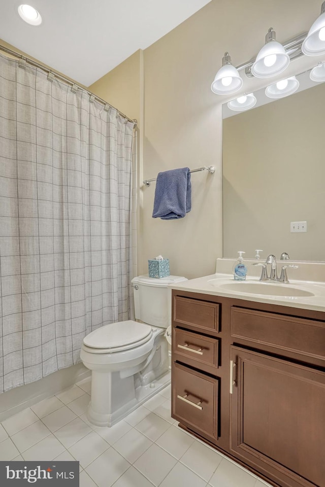 bathroom featuring tile patterned flooring, vanity, a shower with shower curtain, and toilet