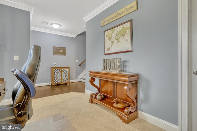 carpeted home office featuring crown molding