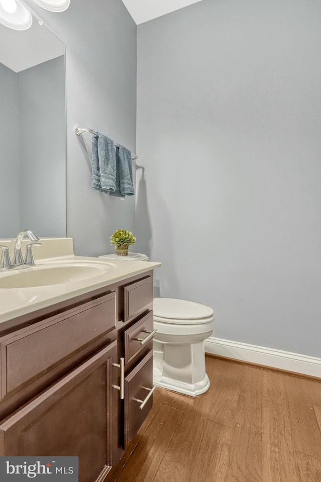 bathroom featuring vanity, toilet, and wood-type flooring