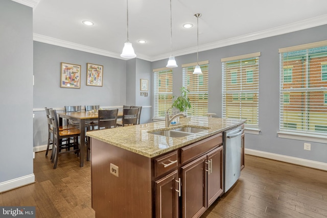 kitchen with pendant lighting, dishwasher, a center island with sink, sink, and light stone countertops