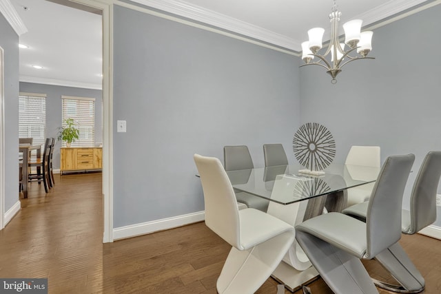 dining room featuring crown molding, wood-type flooring, and an inviting chandelier