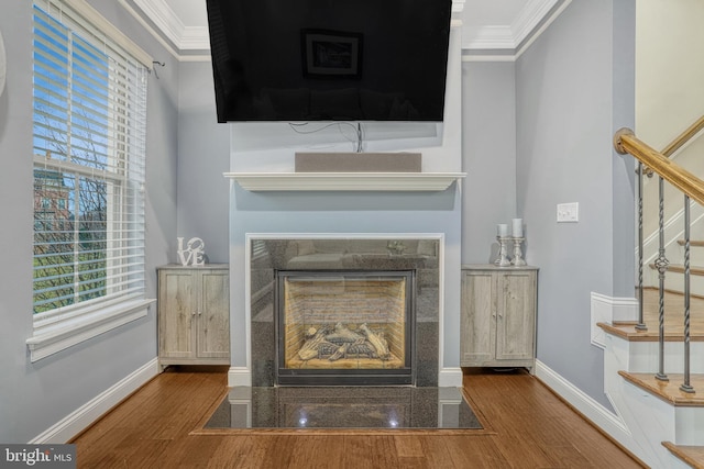 details with hardwood / wood-style flooring and crown molding