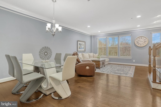 dining area featuring hardwood / wood-style flooring, a chandelier, and ornamental molding