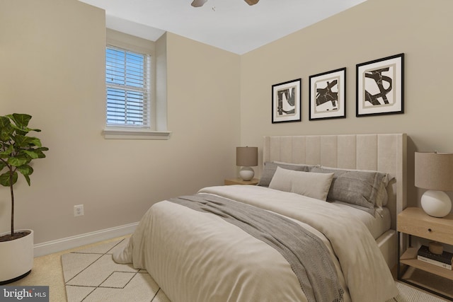 bedroom with ceiling fan and light carpet