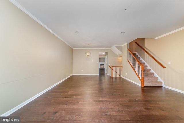 unfurnished living room featuring crown molding, dark wood-type flooring, and a notable chandelier