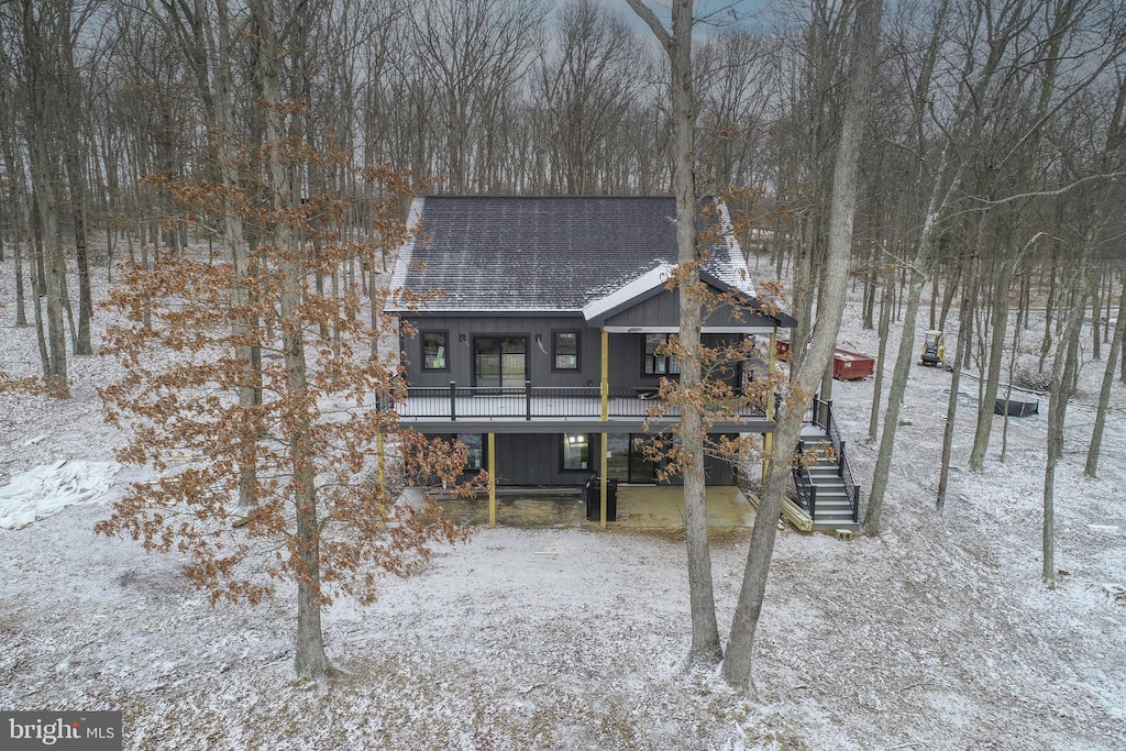 snow covered property with a porch