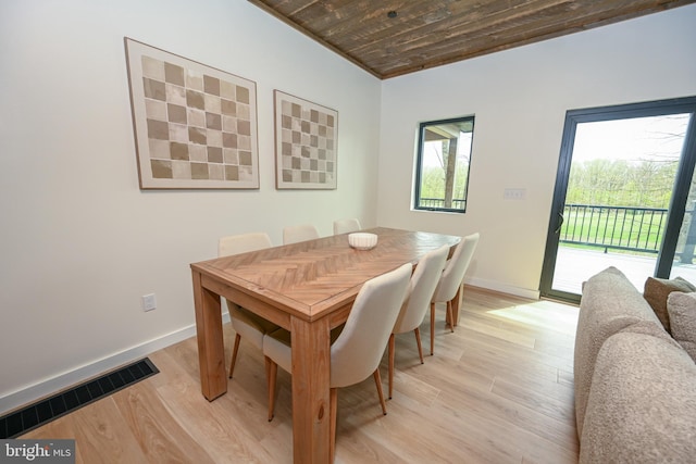 dining space featuring wood ceiling, baseboards, and light wood-type flooring
