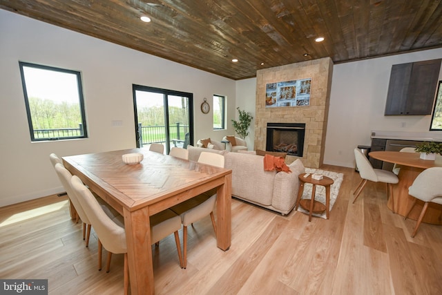 dining room featuring wooden ceiling, light wood-type flooring, a fireplace, baseboards, and recessed lighting