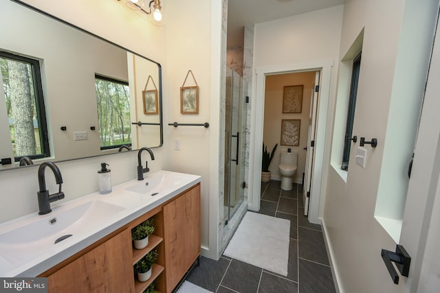 bathroom with tile patterned floors, a shower stall, toilet, and double vanity