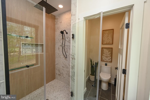 full bath with walk in shower, toilet, and tile patterned floors