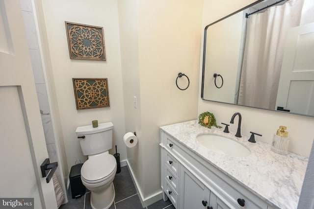 bathroom featuring tile patterned floors, vanity, toilet, and baseboards