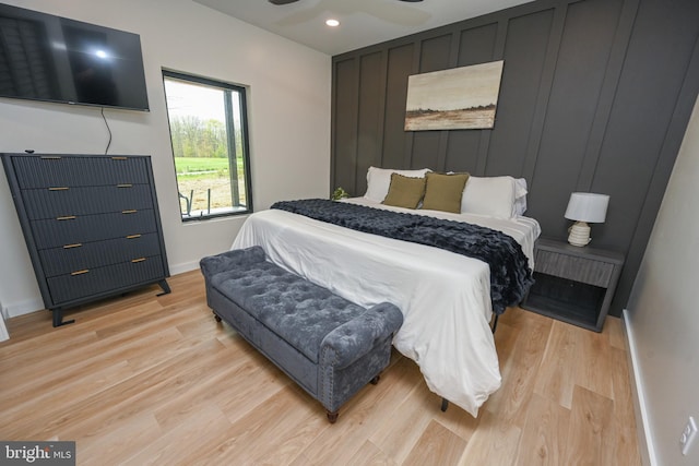 bedroom with light wood-style flooring, baseboards, and recessed lighting