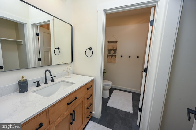 bathroom featuring toilet and vanity