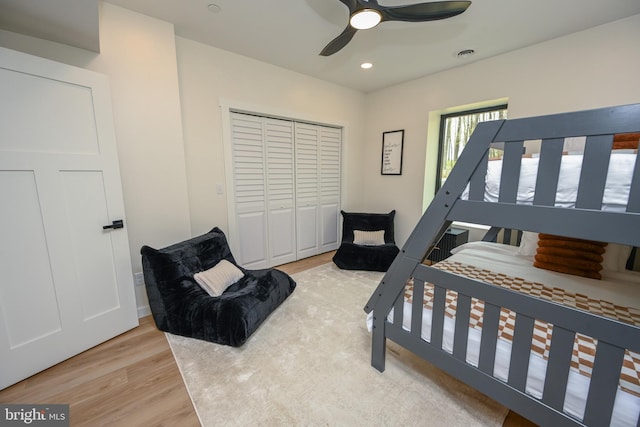 bedroom featuring light wood-style floors, a closet, recessed lighting, and a ceiling fan