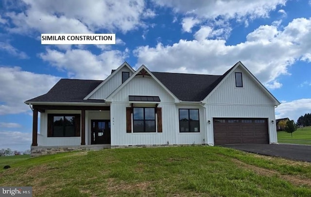 modern inspired farmhouse featuring a garage and a front yard