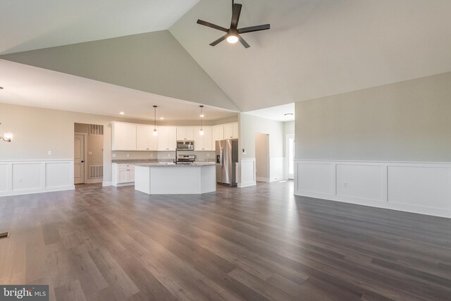 unfurnished living room featuring ceiling fan, dark hardwood / wood-style flooring, and high vaulted ceiling