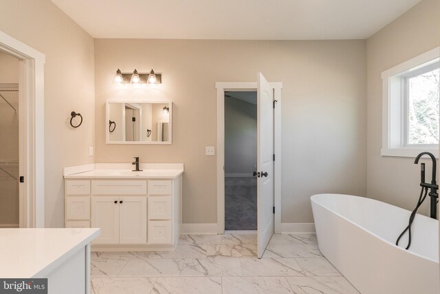 bathroom with vanity and a tub to relax in