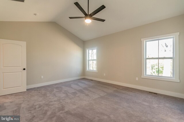 carpeted empty room with vaulted ceiling and ceiling fan