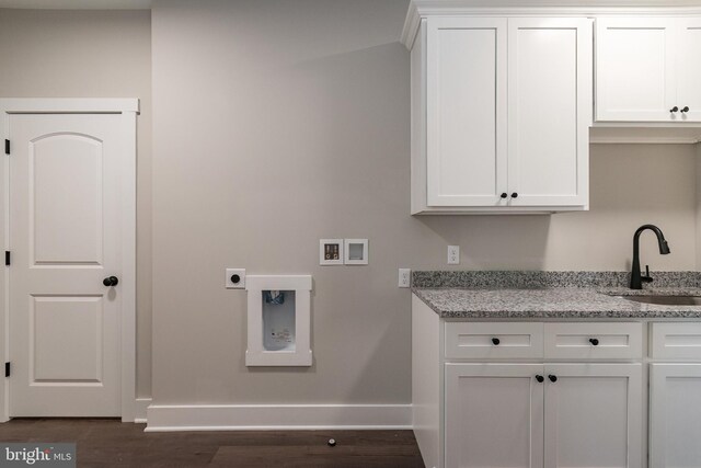 clothes washing area with cabinets, hookup for a washing machine, electric dryer hookup, dark wood-type flooring, and sink