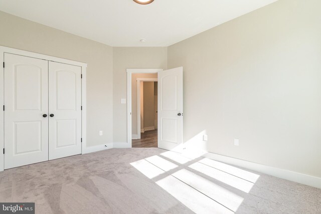 unfurnished bedroom featuring carpet and a closet