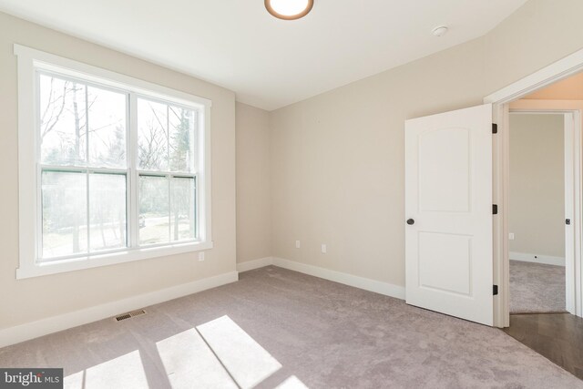 unfurnished room with light colored carpet