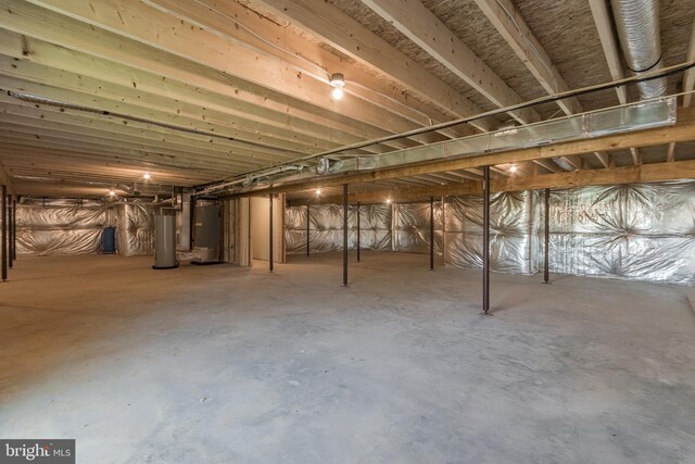 basement featuring heating unit and gas water heater