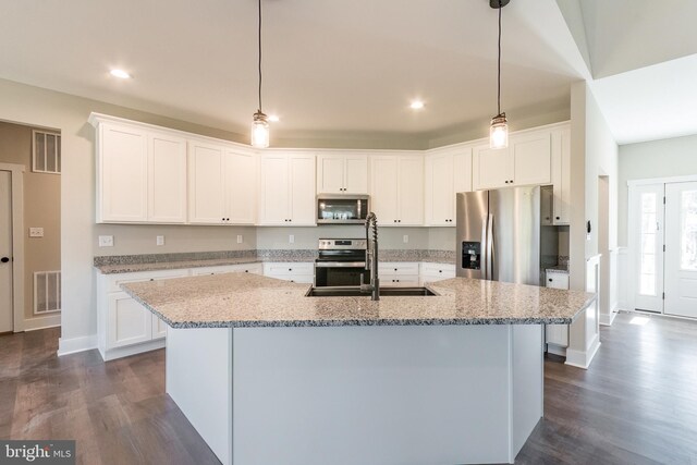 kitchen featuring appliances with stainless steel finishes, sink, a center island with sink, dark hardwood / wood-style floors, and white cabinetry