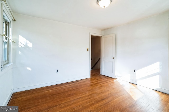 unfurnished room with wood-type flooring