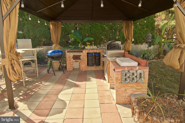 view of patio / terrace with a gazebo, a grill, and exterior kitchen