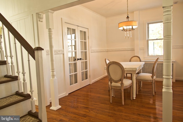 dining room featuring dark hardwood / wood-style flooring, crown molding, and french doors