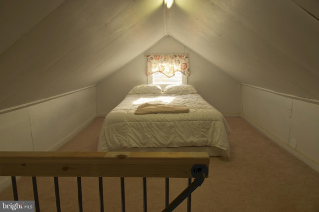 carpeted bedroom with lofted ceiling