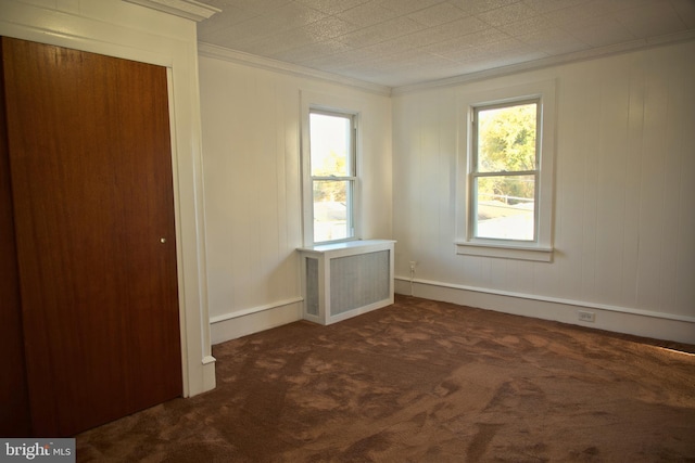 carpeted spare room featuring radiator and ornamental molding