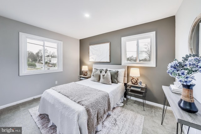 carpeted bedroom with multiple windows