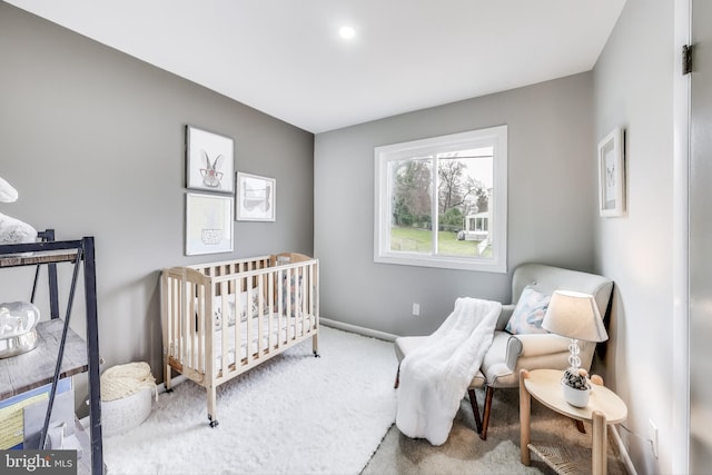 carpeted bedroom with a crib