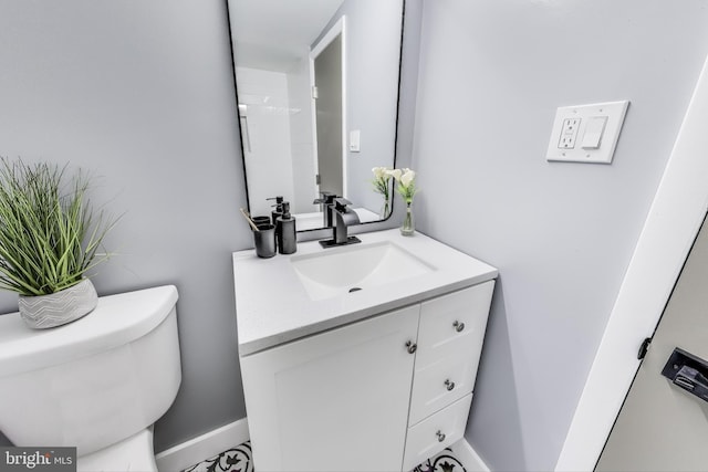 bathroom featuring vanity and toilet