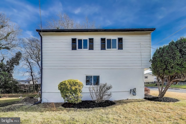 view of property exterior with a yard