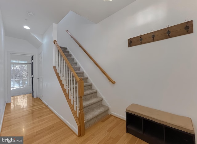 stairway with hardwood / wood-style floors