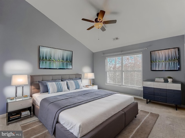 carpeted bedroom with ceiling fan and vaulted ceiling