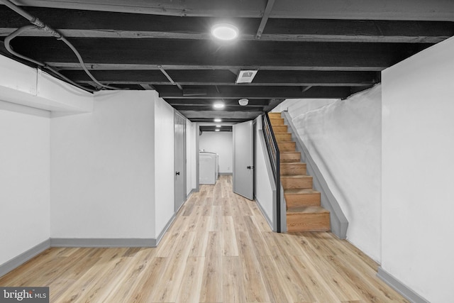 basement with light hardwood / wood-style floors