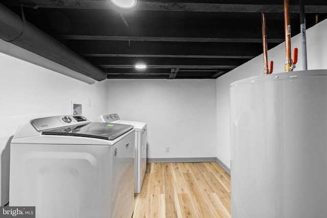 laundry room featuring separate washer and dryer, hardwood / wood-style floors, and gas water heater