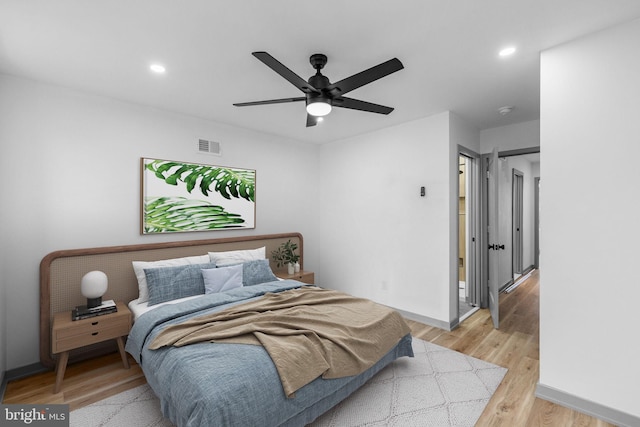 bedroom with light hardwood / wood-style flooring and ceiling fan