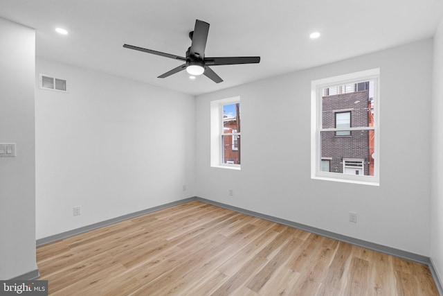 spare room with ceiling fan and light hardwood / wood-style floors