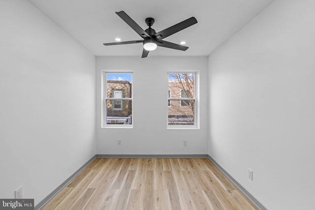 empty room with ceiling fan and light wood-type flooring