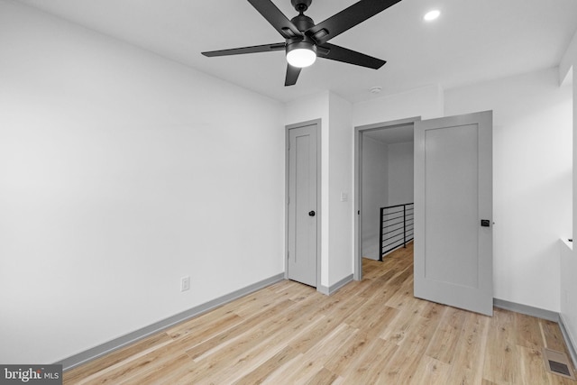 unfurnished bedroom featuring ceiling fan and light wood-type flooring