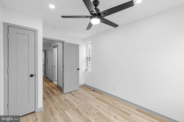 unfurnished bedroom featuring ceiling fan and light hardwood / wood-style floors