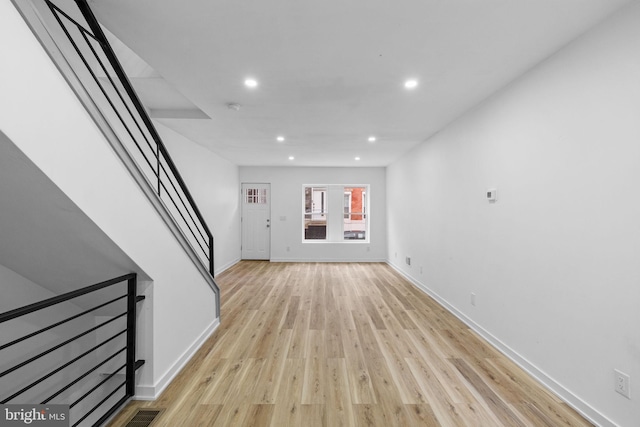 unfurnished living room featuring light wood-type flooring